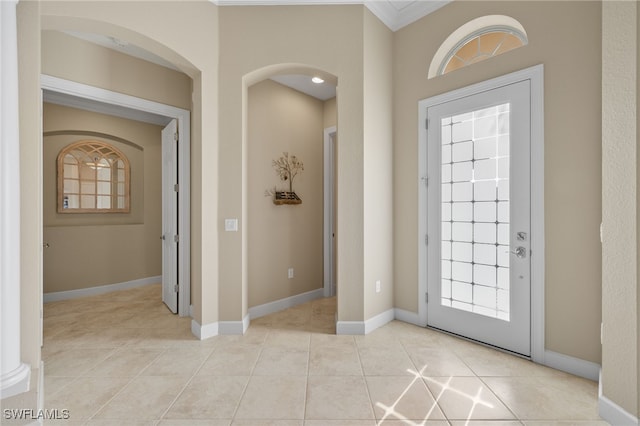 tiled entrance foyer with ornamental molding