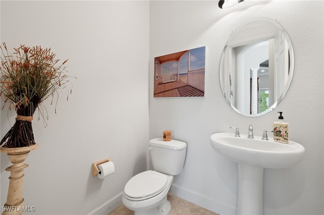 bathroom with sink, tile patterned floors, and toilet