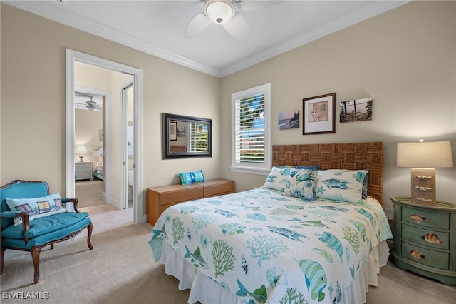 carpeted bedroom featuring ceiling fan, ornamental molding, and connected bathroom