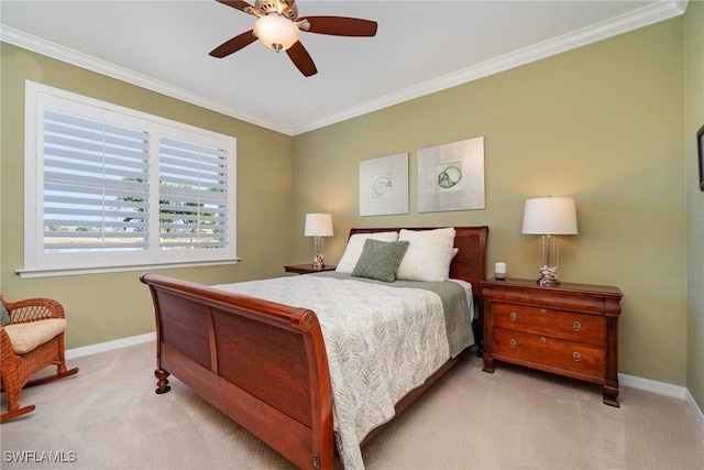 carpeted bedroom with ornamental molding and ceiling fan