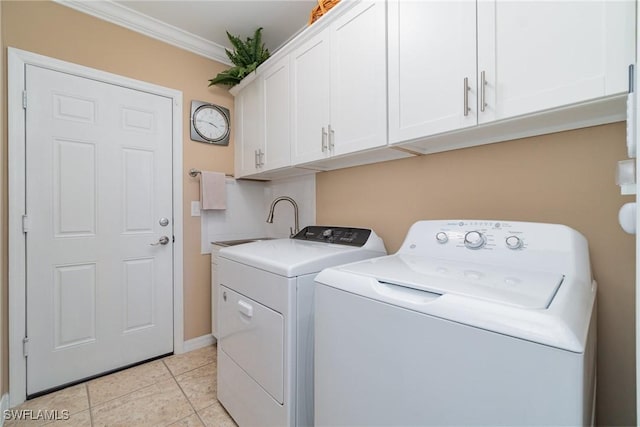 laundry area with sink, crown molding, cabinets, light tile patterned floors, and washing machine and dryer