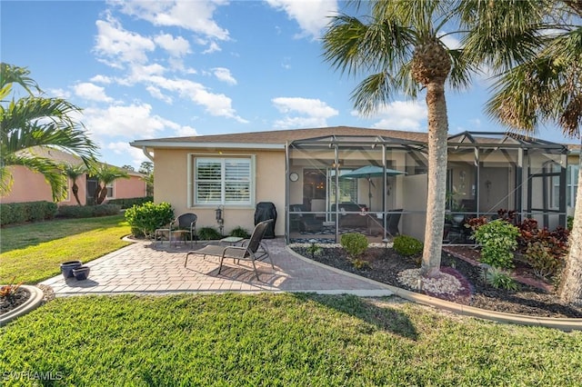 rear view of house with a yard, a lanai, and a patio area