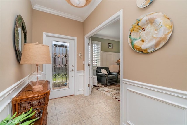 tiled entryway featuring crown molding