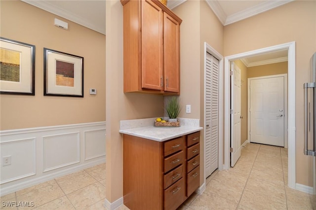 kitchen with light stone counters, light tile patterned floors, and crown molding