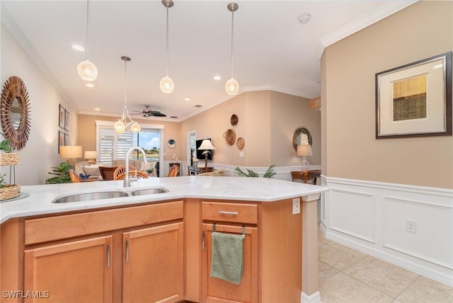 kitchen featuring crown molding, sink, and light tile patterned floors