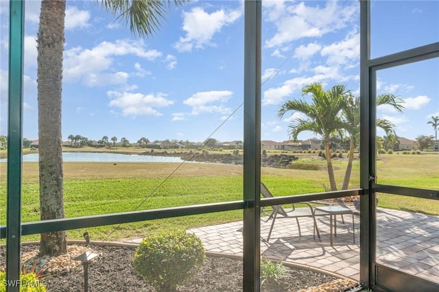 unfurnished sunroom with a water view