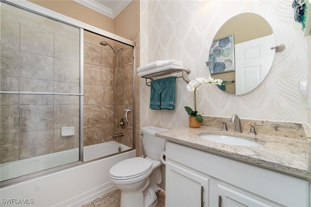 full bathroom featuring ornamental molding, combined bath / shower with glass door, vanity, and toilet