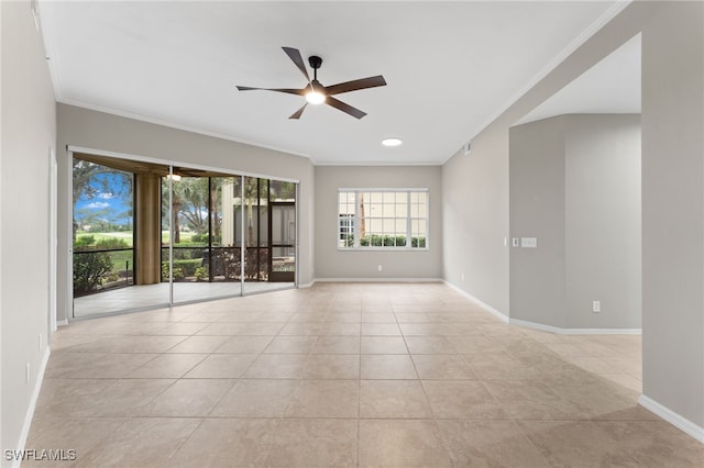 unfurnished room with a ceiling fan, crown molding, baseboards, and light tile patterned floors