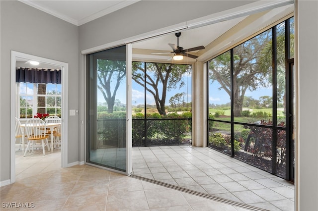 unfurnished sunroom featuring ceiling fan