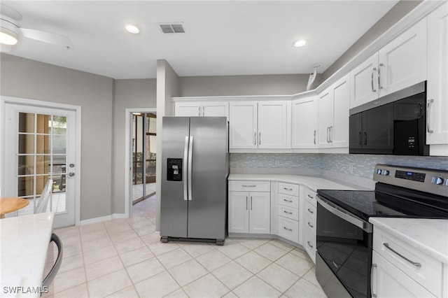 kitchen with tasteful backsplash, white cabinetry, light tile patterned floors, light stone counters, and stainless steel appliances