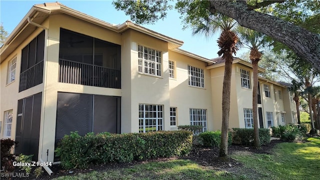 view of side of home with stucco siding