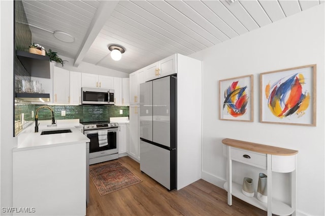 kitchen with sink, white cabinetry, backsplash, stainless steel appliances, and wood-type flooring