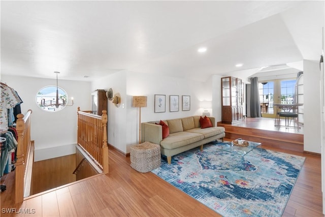 living room with a wealth of natural light, hardwood / wood-style floors, and french doors