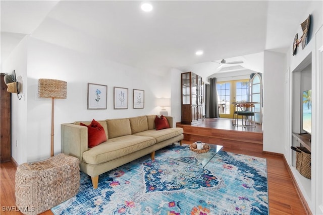 living room featuring hardwood / wood-style flooring, vaulted ceiling, ceiling fan, and french doors