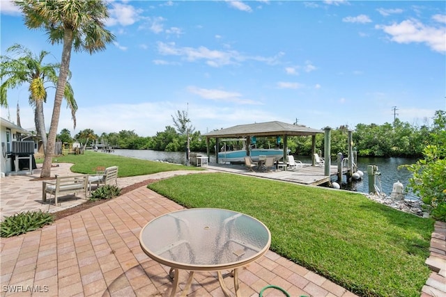 view of patio featuring a water view, a gazebo, and a boat dock