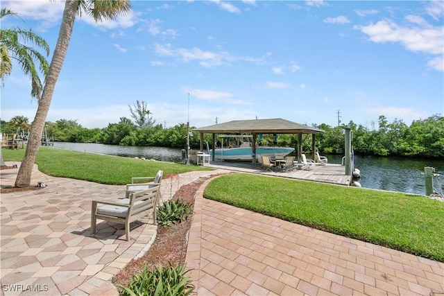 view of property's community featuring a yard, a boat dock, and a water view