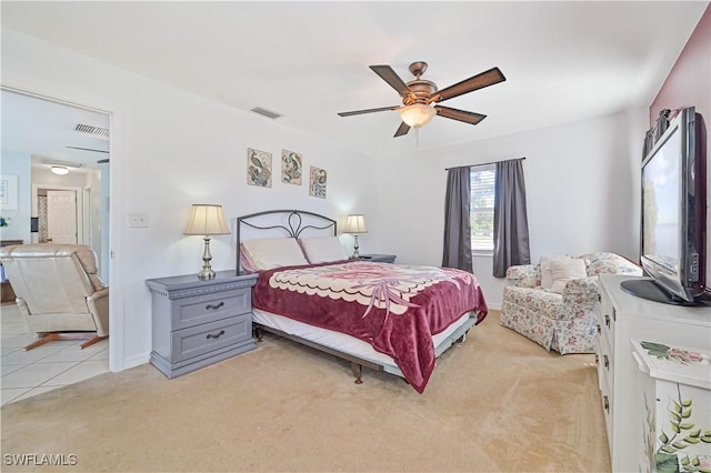 bedroom featuring light carpet and ceiling fan