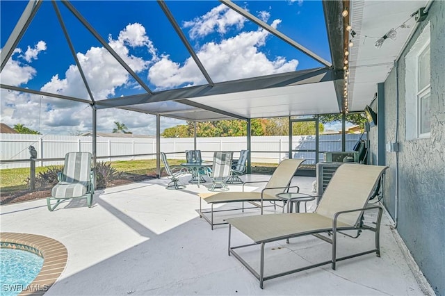 view of patio / terrace featuring glass enclosure