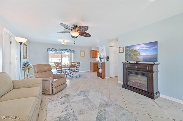 living room with ceiling fan and light tile patterned floors