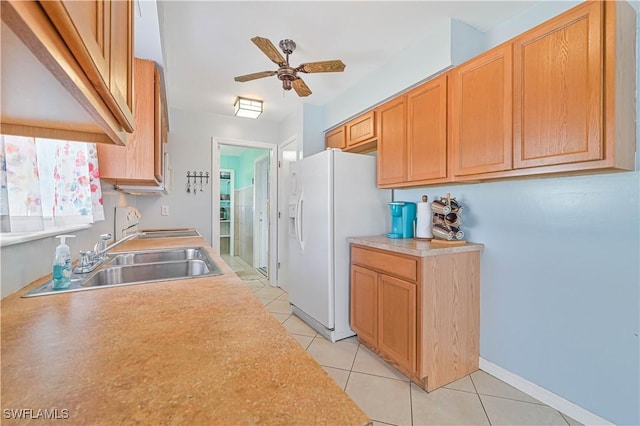 kitchen featuring sink, range, light tile patterned floors, ceiling fan, and white refrigerator with ice dispenser