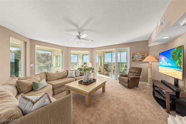 2619 Wulfert Rd Unit 5, Sanibel, FL 33957 - carpeted living room featuring ceiling fan and plenty of natural light