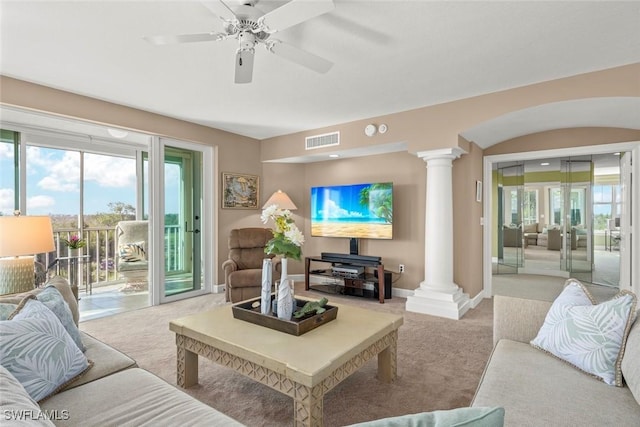 2619 Wulfert Rd Unit 5, Sanibel, FL 33957 - living area with decorative columns, carpet, baseboards, and ceiling fan