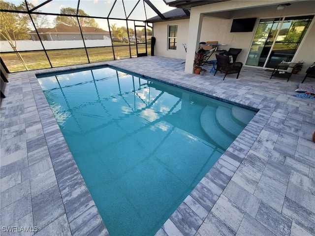 view of pool featuring a patio area and glass enclosure