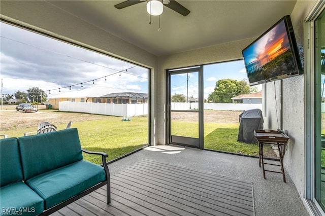 sunroom / solarium featuring ceiling fan