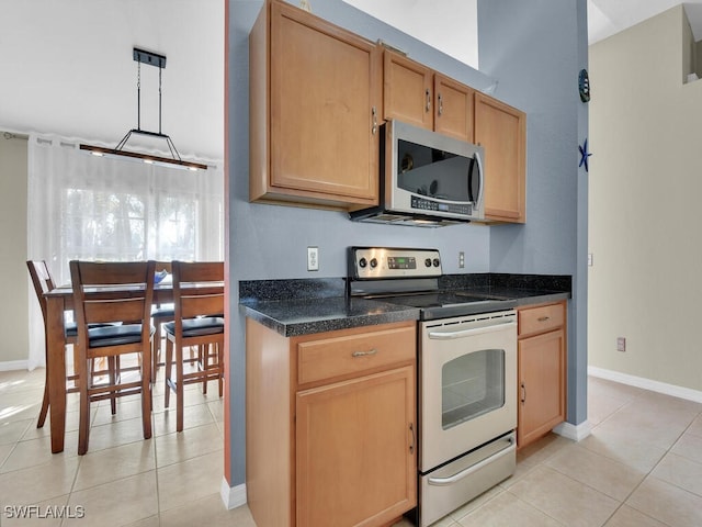 kitchen featuring pendant lighting, appliances with stainless steel finishes, and light tile patterned floors