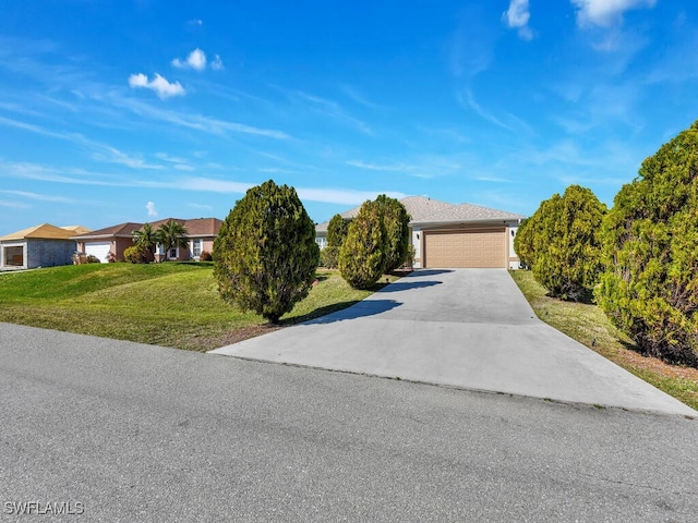 ranch-style home with a garage and a front lawn