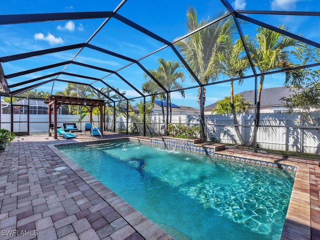 view of swimming pool with pool water feature, glass enclosure, a pergola, and a patio area