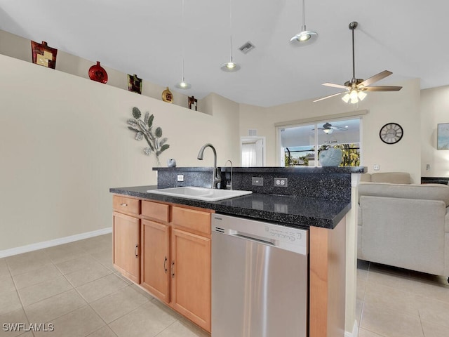 kitchen with sink, light tile patterned floors, dishwasher, a center island with sink, and light brown cabinetry