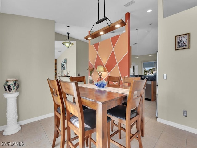 tiled dining area featuring lofted ceiling