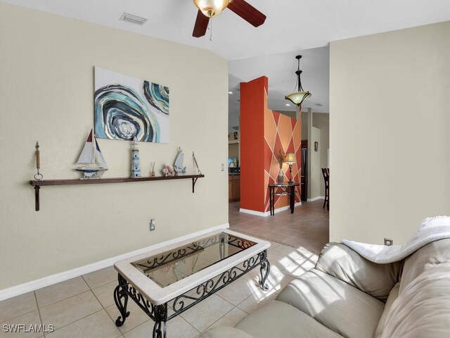 tiled living room with ceiling fan