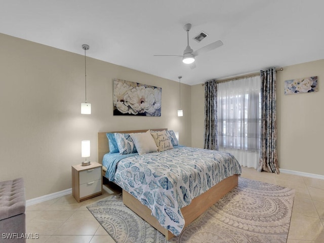 tiled bedroom featuring ceiling fan