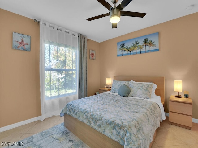 tiled bedroom featuring ceiling fan