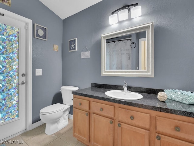 bathroom featuring tile patterned flooring, vanity, toilet, and a shower with shower curtain