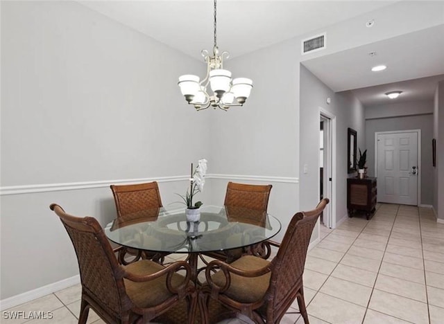 tiled dining area featuring a notable chandelier