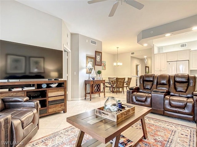 tiled living room featuring ceiling fan with notable chandelier