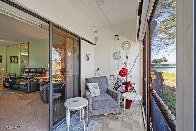 sunroom / solarium with a water view