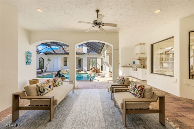 interior space featuring ceiling fan and a textured ceiling