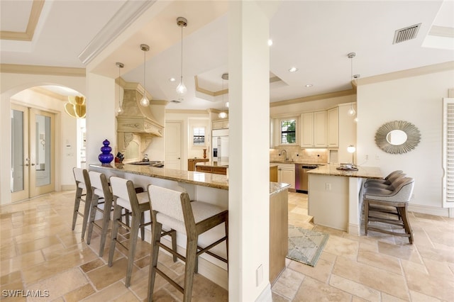 kitchen with dishwasher, a kitchen breakfast bar, paneled refrigerator, decorative light fixtures, and kitchen peninsula