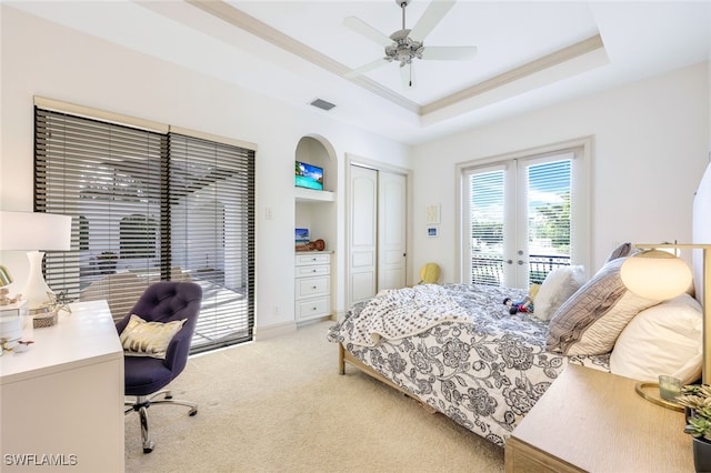 carpeted bedroom with french doors, crown molding, access to exterior, and a tray ceiling