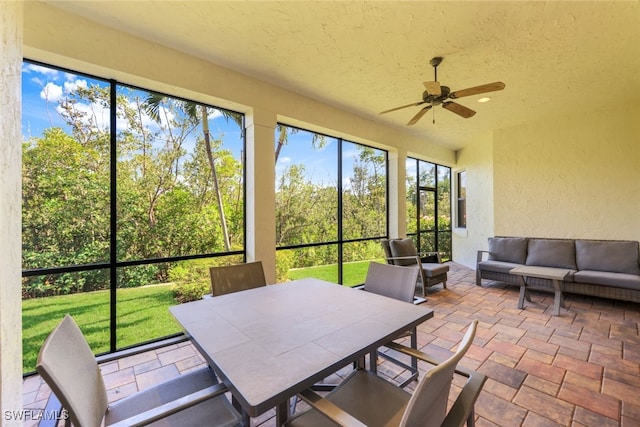 sunroom / solarium featuring ceiling fan