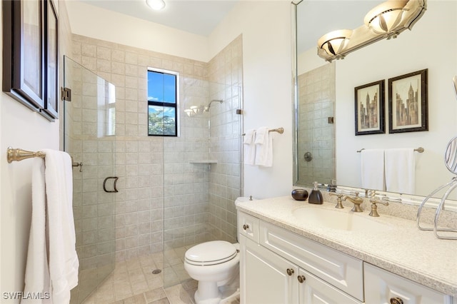 bathroom with vanity, toilet, and a shower with shower door