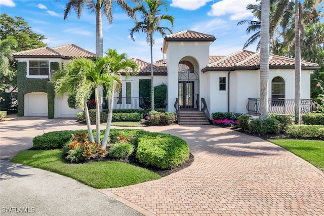 mediterranean / spanish-style house with a garage