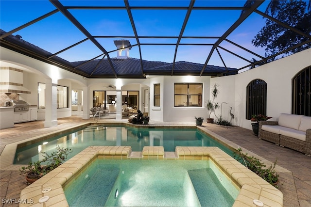 pool at dusk with area for grilling, a grill, a patio, and an in ground hot tub