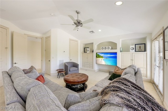 carpeted living room featuring lofted ceiling, built in shelves, and ceiling fan