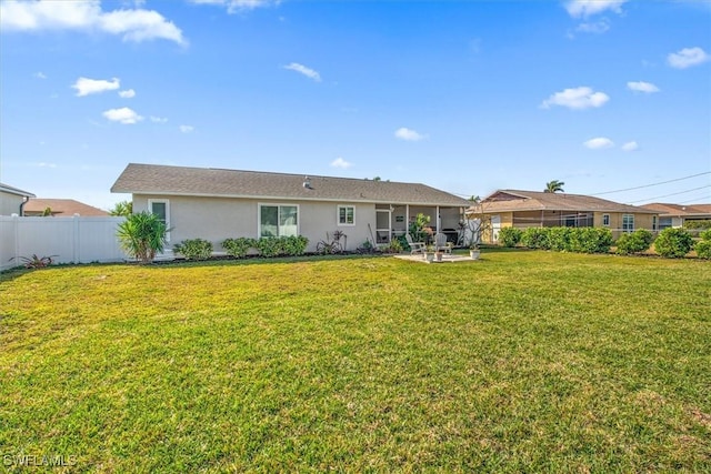 rear view of property with a yard and a patio