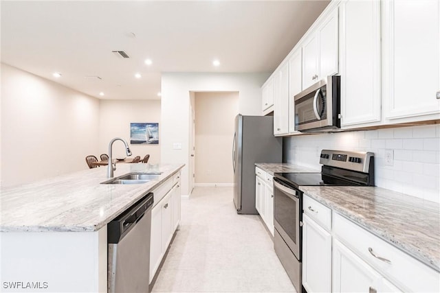 kitchen with white cabinetry, sink, a kitchen island with sink, and stainless steel appliances